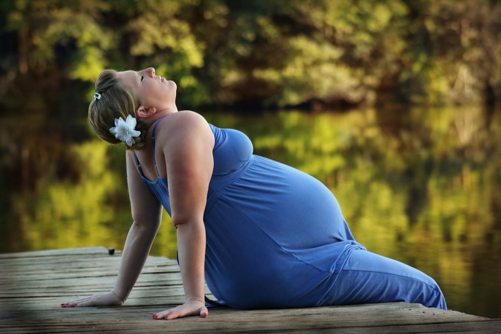 pregnant woman relaxing at a river